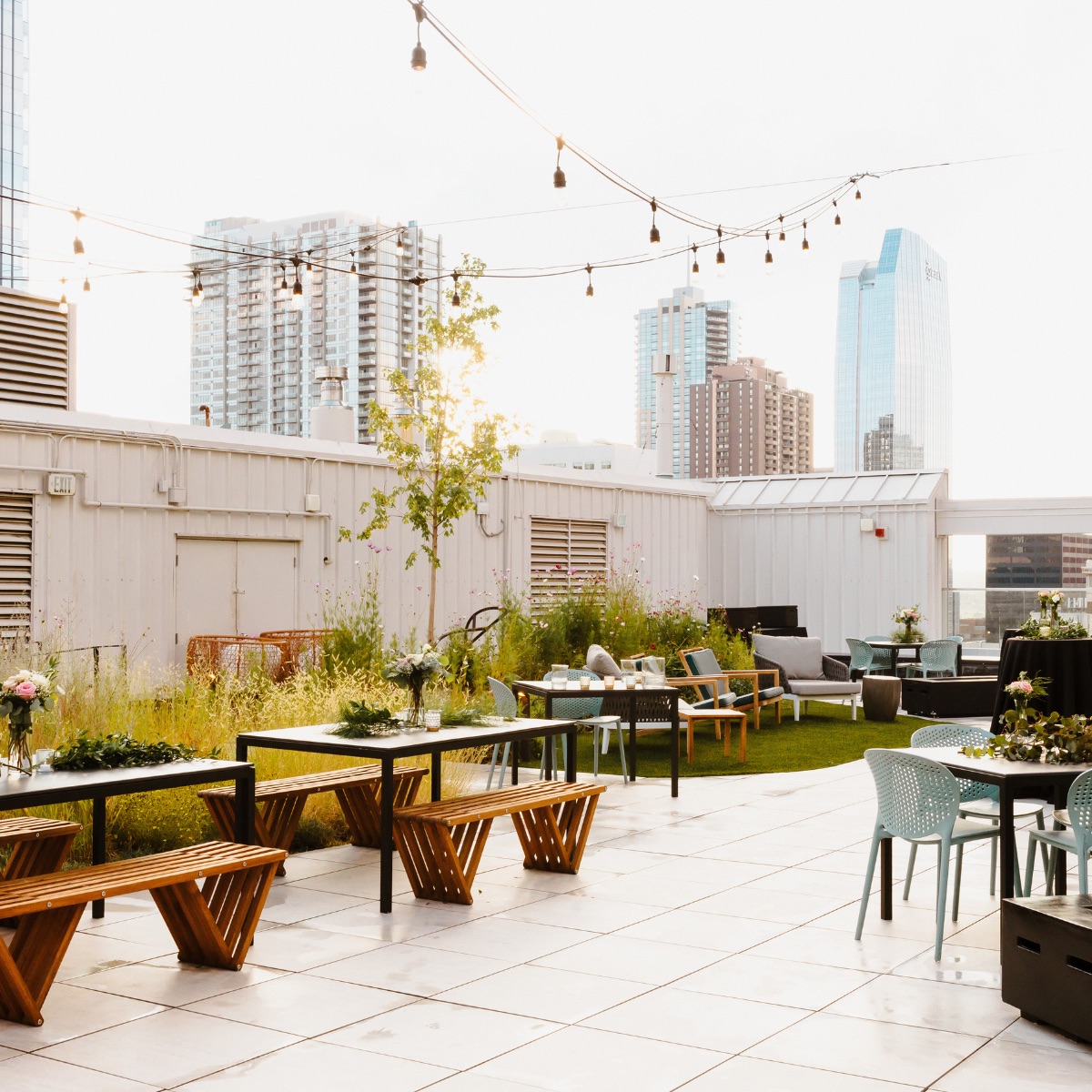 Rooftop 1630, Denver, twilight view of the rooftop terrace with cafe lights and downtown skyline